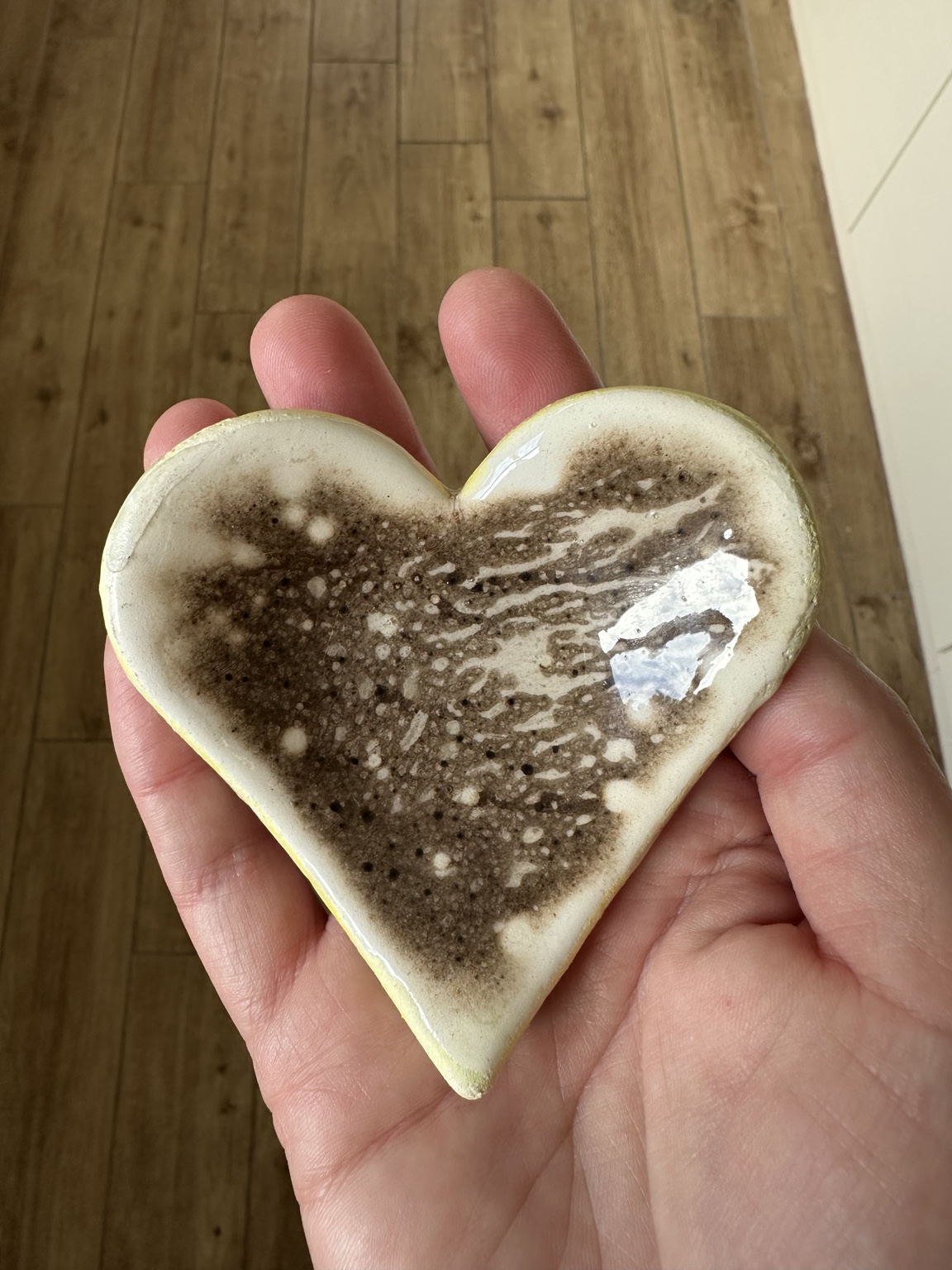 Cream and sepia Obvara heart held in a hand